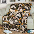 Alaskan Malamute blanket styled on a sofa with rustic sunflower and dog artwork