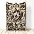 Alaskan Malamute throw blanket displayed upright with multiple dog portraits, daisies, and rustic woodland artwork