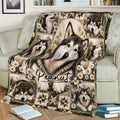 Alaskan Malamute throw blanket spread across a couch with a central dog portrait, floral accents, and rustic artwork