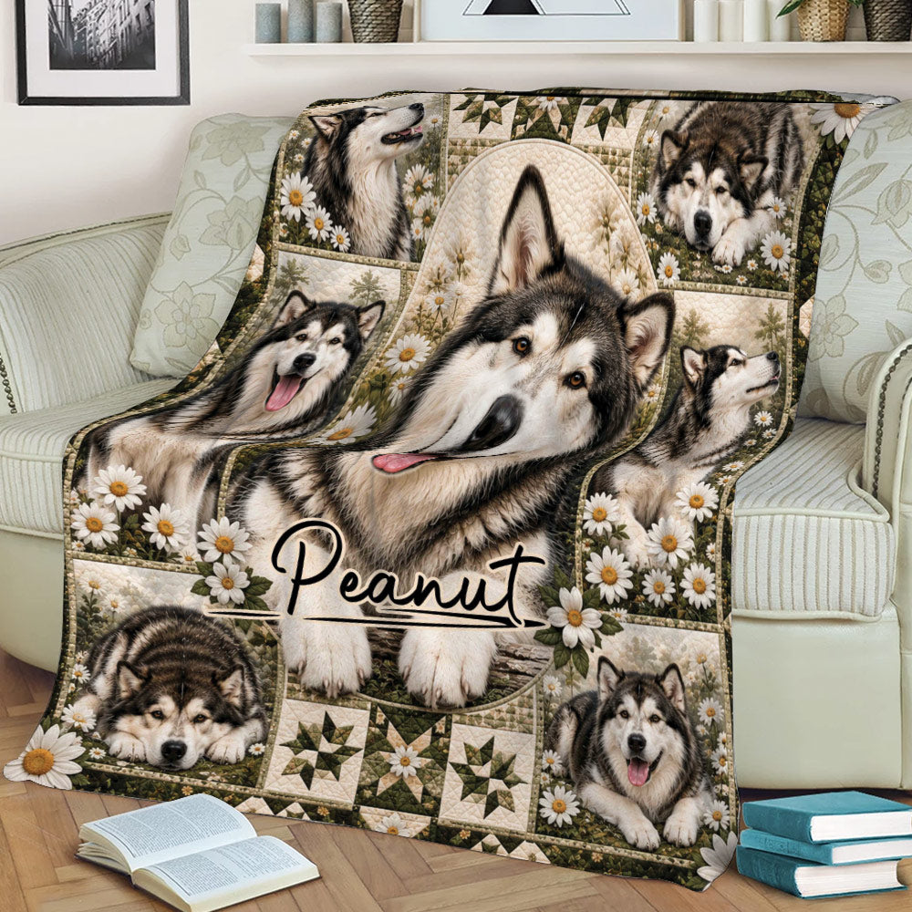 Alaskan Malamute throw blanket spread across a couch with a central dog portrait, floral accents, and rustic artwork