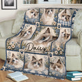 Close view of a Ragdoll cat throw blanket on a couch with floral panels, blue borders, and multiple cat portraits