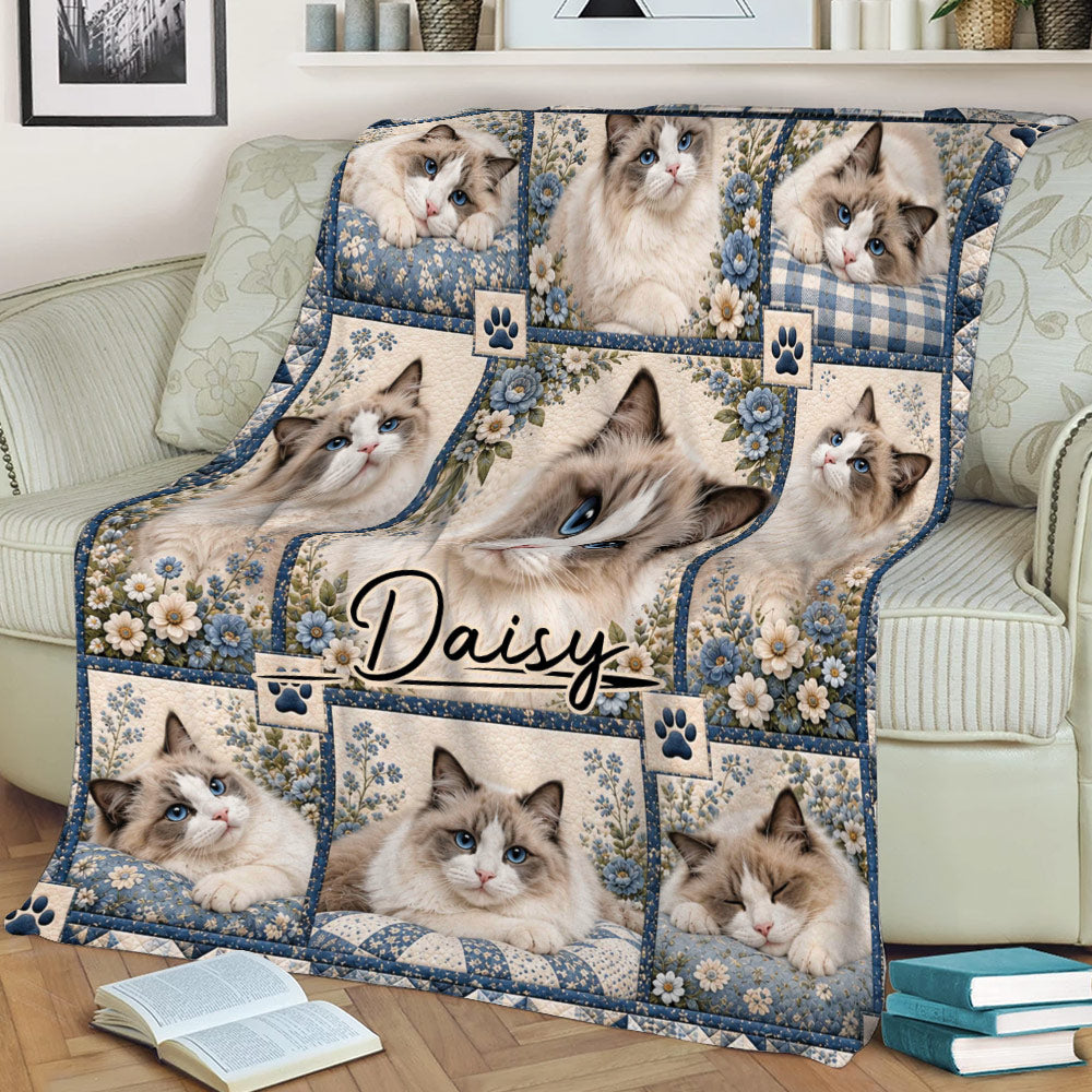 Close view of a Ragdoll cat throw blanket on a couch with floral panels, blue borders, and multiple cat portraits