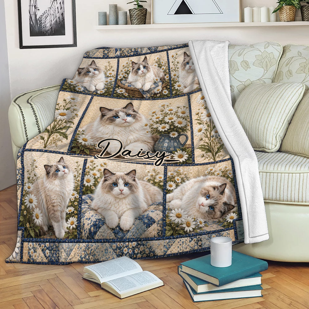 Ragdoll cat blanket draped over a sofa, showing blue-eyed cats, daisies, and blue floral accents