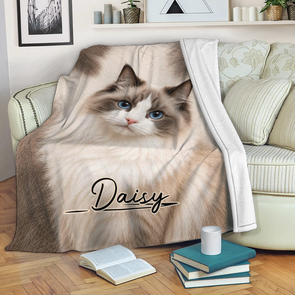 Ragdoll cat blanket draped over a sofa in a cozy living room setting