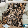 Close lifestyle view of a Great Dane throw blanket featuring dog portraits, paw prints, and warm rustic lodge artwork