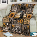 Close view of a Great Dane throw blanket on a sofa featuring dog portraits, sunflowers, and rustic countryside artwork