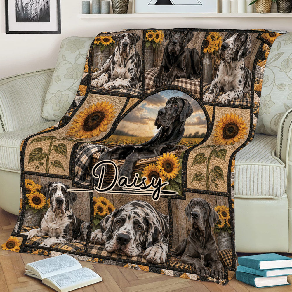 Close view of a Great Dane throw blanket on a sofa featuring dog portraits, sunflowers, and rustic countryside artwork