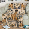 Great Dane blanket styled on a couch, featuring dog portraits surrounded by blue and cream flowers
