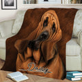 Bloodhound throw blanket displayed across a sofa with detailed brown dog artwork