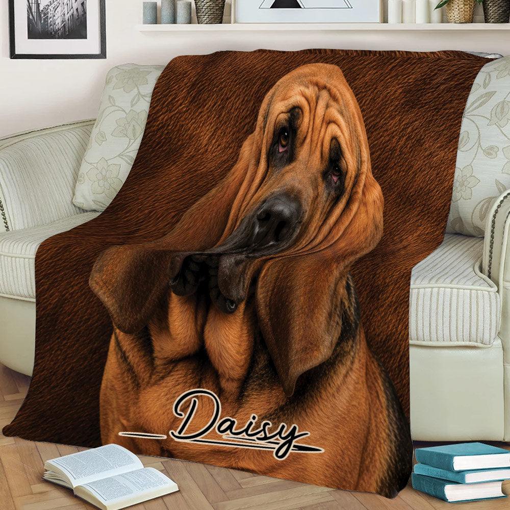 Bloodhound throw blanket displayed across a sofa with detailed brown dog artwork
