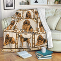 Bloodhound throw blanket draped over a sofa with repeated dog artwork and cozy neutral decor