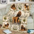 Daisy-themed Bloodhound throw blanket draped over a sofa with multiple hound illustrations