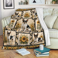 Rat Terrier blanket draped over a sofa, featuring black and white dogs with warm sunflower artwork