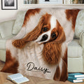 Close view of a Cavalier King Charles Spaniel throw blanket styled across a sofa