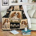 Cavalier King Charles Spaniel throw blanket displayed on a sofa with floral artwork