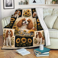 Cavalier King Charles throw blanket draped over a sofa with sunflower collage design