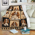 Cavalier King Charles Spaniel throw blanket draped over a sofa in a cozy living room