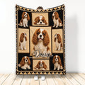 Cavalier King Charles Spaniel blanket displayed upright with a multi-panel dog collage and black and tan border