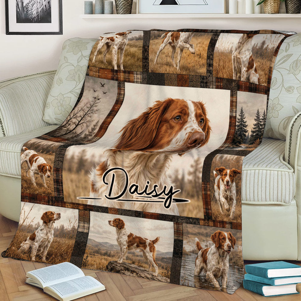 Close view of a Brittany Spaniel throw blanket displayed on a couch with countryside dog artwork
