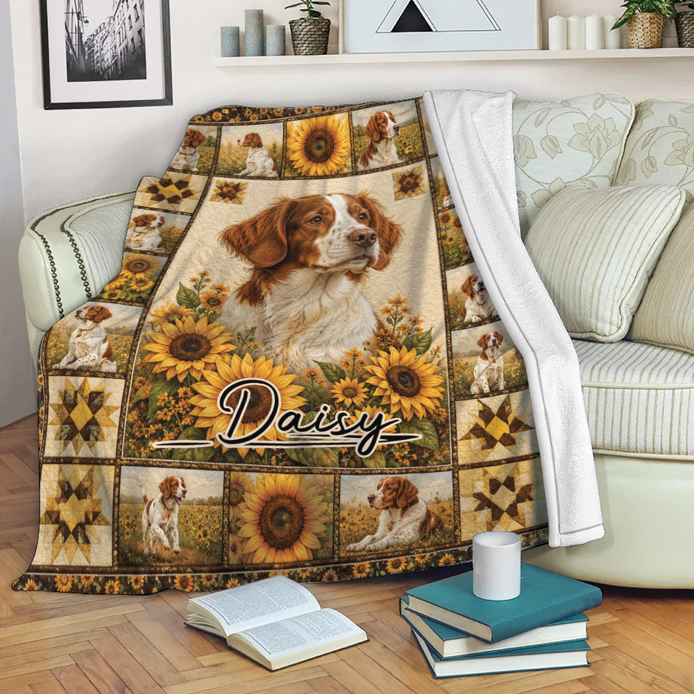 Brittany Spaniel throw blanket displayed on a sofa with sunflower scenes, rustic artwork, and repeated dog portraits