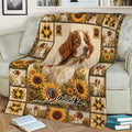 Brittany Spaniel blanket draped over a couch, showcasing a large dog portrait, sunflowers, and warm country-style artwork