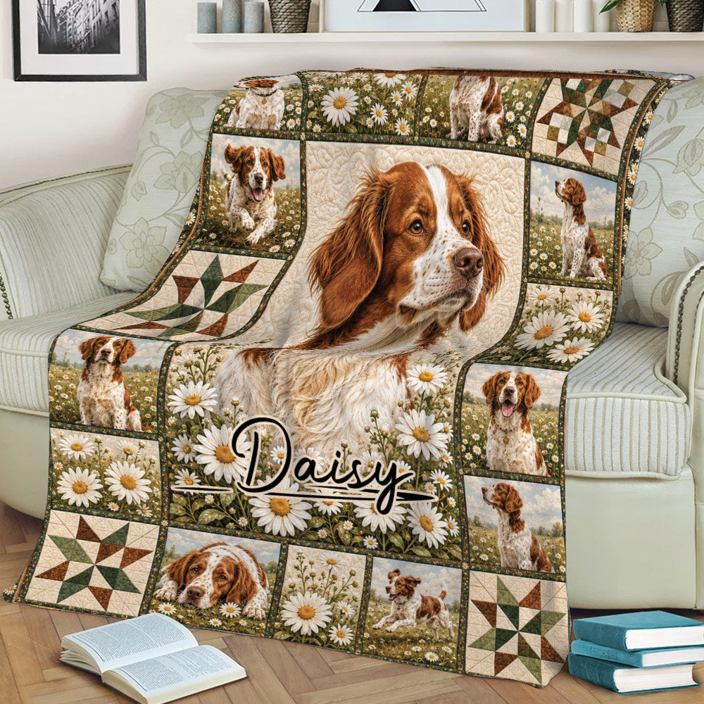 Brittany Spaniel blanket displayed on a sofa, featuring a central dog portrait, meadow flowers, and framed panels