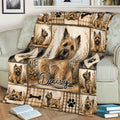 Close view of Cairn Terrier throw blanket on a sofa featuring a central dog portrait and plaid border