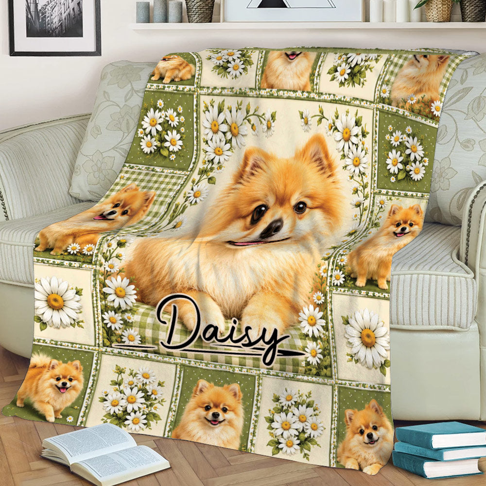 Close lifestyle view of a Pomeranian blanket on a sofa featuring a large dog portrait, daisies, and green floral panels