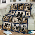 Border Collie throw blanket spread across a sofa, featuring black and white dogs, mountain scenes, and rustic patterns