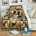 Border Collie throw blanket displayed on a sofa with sunflower artwork and black and white dogs