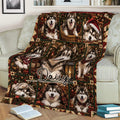 Festive Alaskan Malamute blanket displayed on a couch with Christmas portraits, gifts, and plaid borders