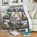 Horse blanket displayed on a sofa with white horse artwork, mountain landscapes, flowers, and pastoral scenery