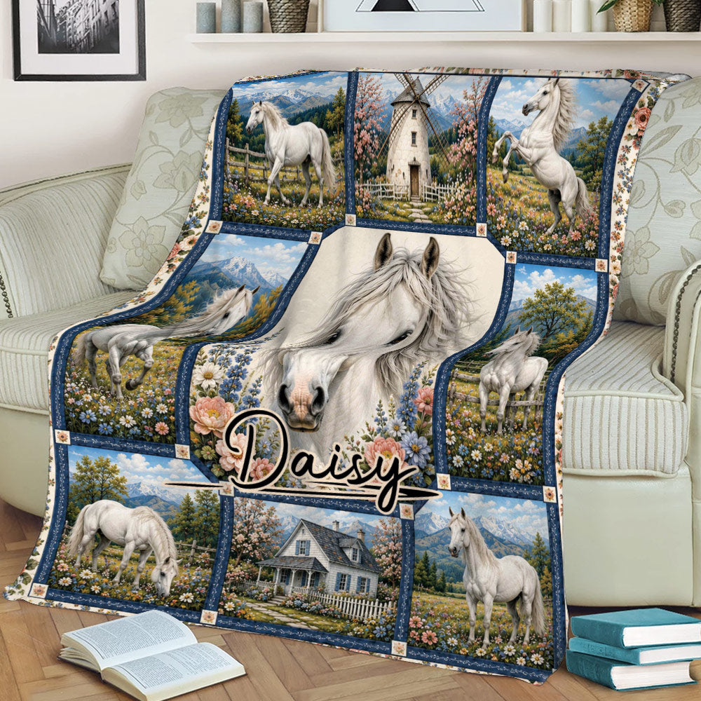 Horse throw blanket draped over a couch, showcasing white horses, wildflower fields, mountains, and a farmhouse