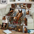 Christmas horse blanket draped across a sofa, showing brown horses, snowy landscapes, wreaths, and rustic holiday decor