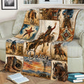 Western rodeo blanket draped over a couch with cowboy scenes, horses, bull riding, boots, and desert scenery