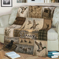Rustic duck hunting blanket draped over a couch with mallards, cattails, a hunter, retriever dog, and wetland scenes