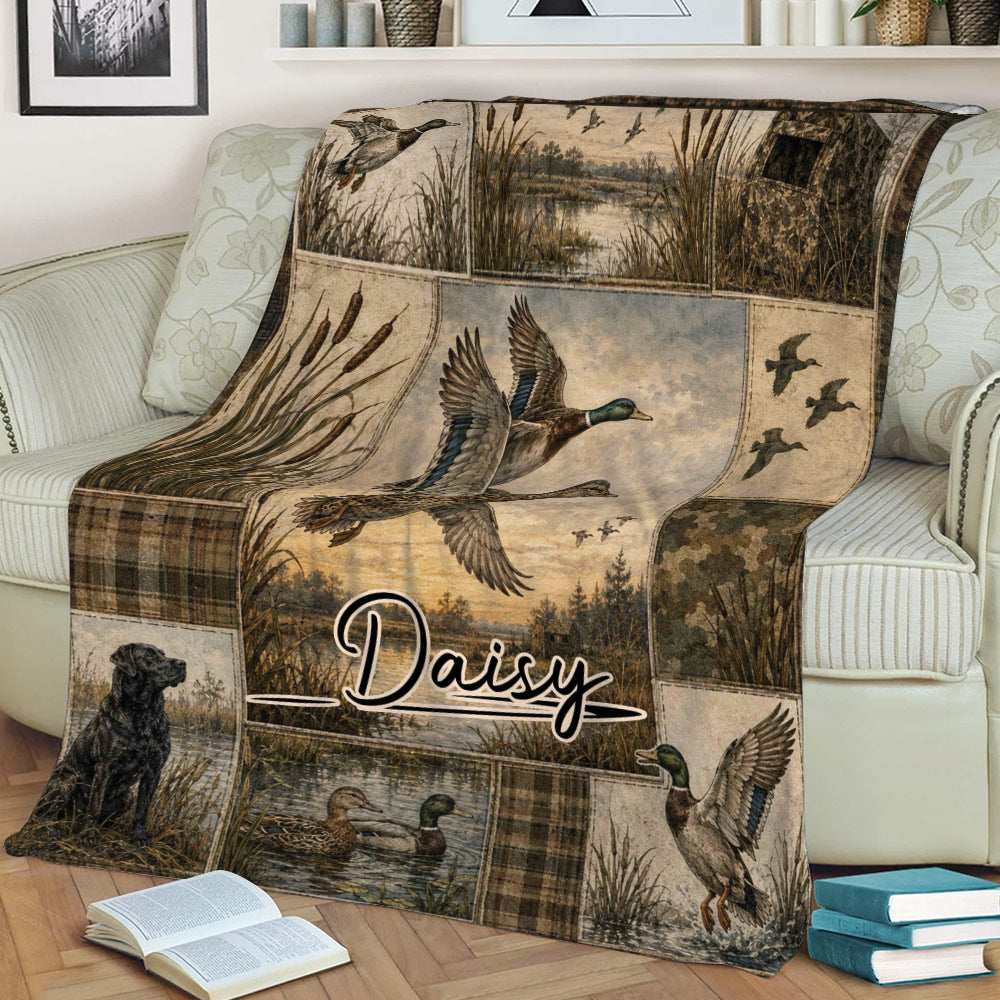 Waterfowl hunting throw blanket draped over a couch with flying ducks, marsh artwork, reeds, and a hunting dog