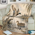 Waterfowl throw blanket draped over a couch with mallards and peaceful marsh scenery