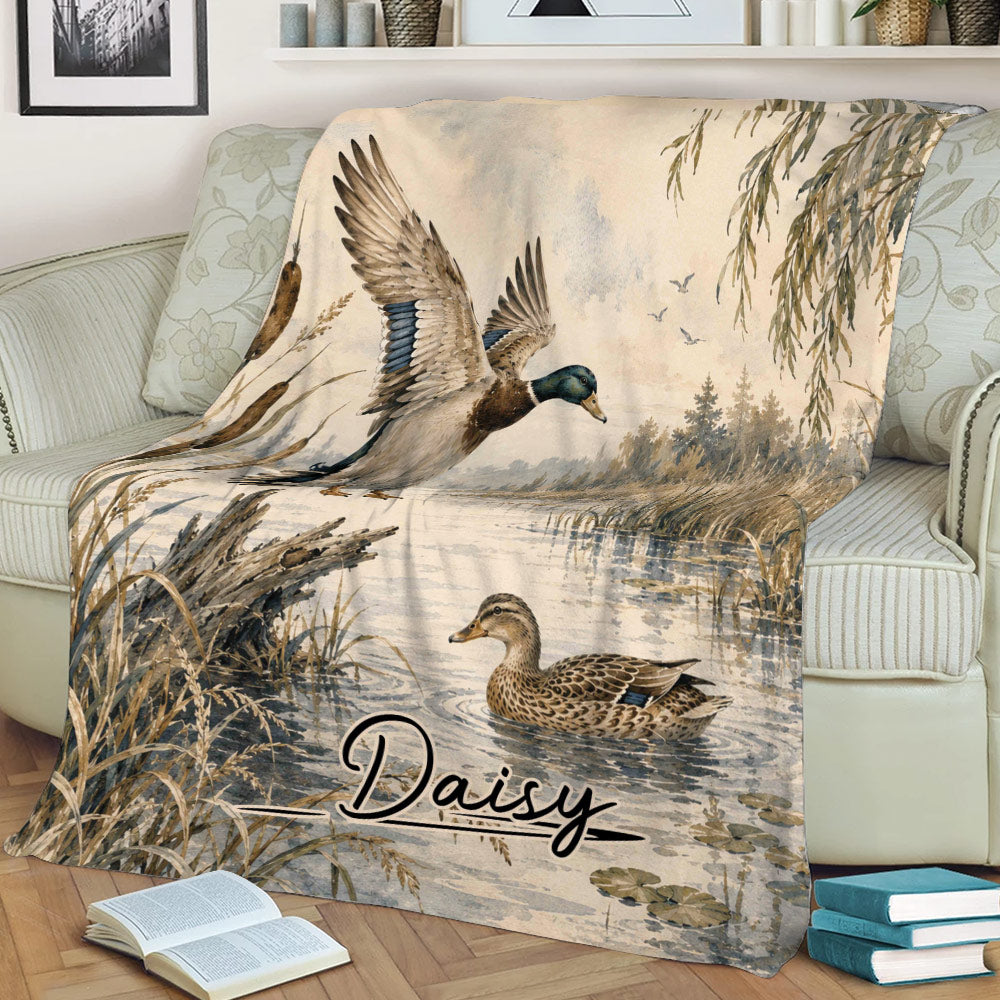 Waterfowl throw blanket draped over a couch with mallards and peaceful marsh scenery
