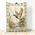 Duck hunting blanket featuring a flying mallard over a marsh scene with cattails and a green plaid border
