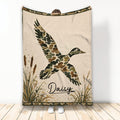 Duck hunting blanket featuring a flying camouflage duck, cattails, marsh grasses, and rustic outdoor artwork