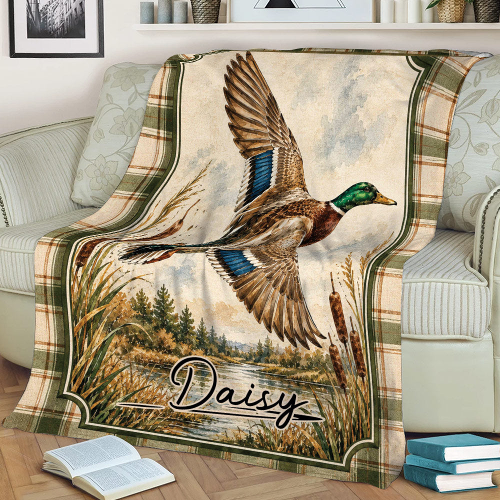 Duck hunting throw blanket draped over a couch, featuring a detailed mallard in a scenic wetland