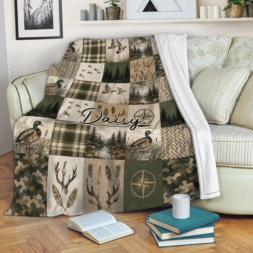 Duck hunting blanket displayed on a sofa with mallards, camouflage, forest, and rustic lodge-style panels
