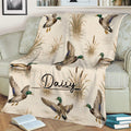 Mallard duck throw blanket styled across a sofa with cattails and marsh water details