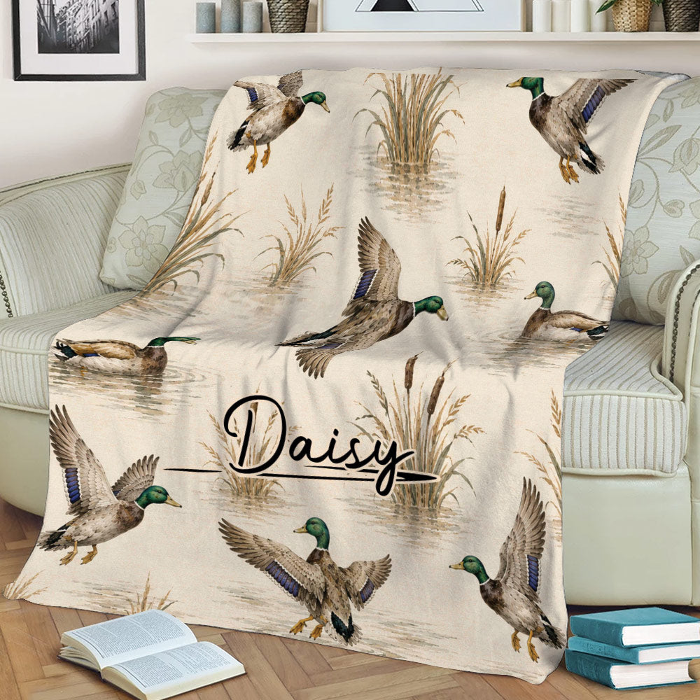 Mallard duck throw blanket styled across a sofa with cattails and marsh water details