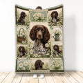 Boykin Spaniel throw blanket featuring a collage of brown dogs and white daisies