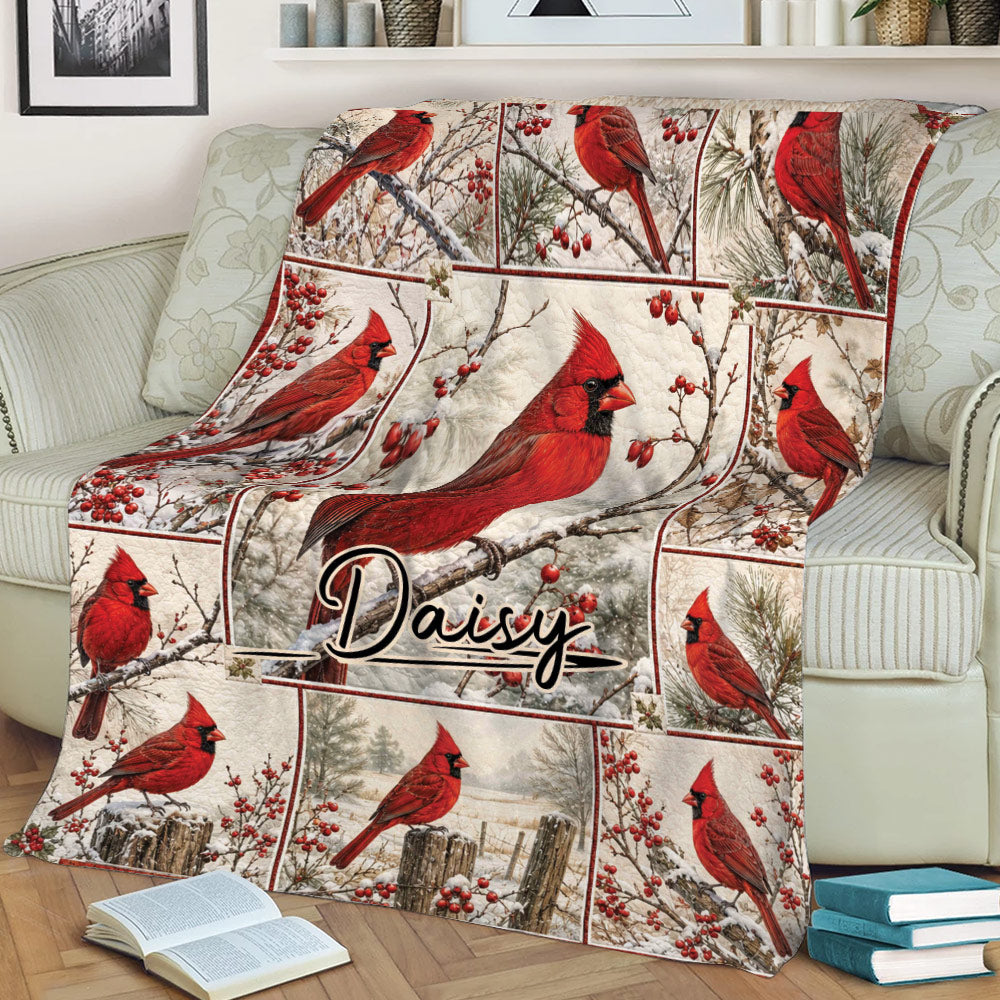 Cardinal blanket displayed on a sofa with vivid red birds and winter woodland artwork