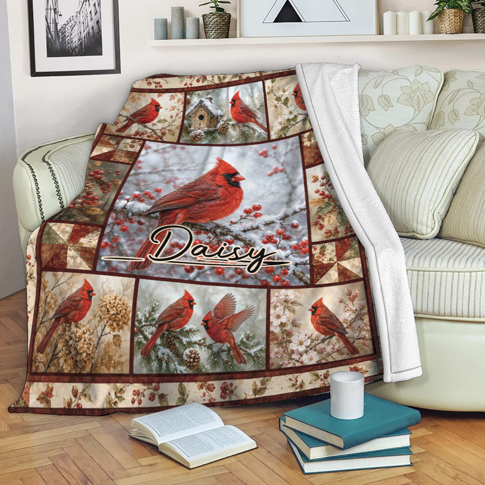 Cardinal blanket displayed on a sofa with red birds, winter berries, snowy branches, and woodland artwork