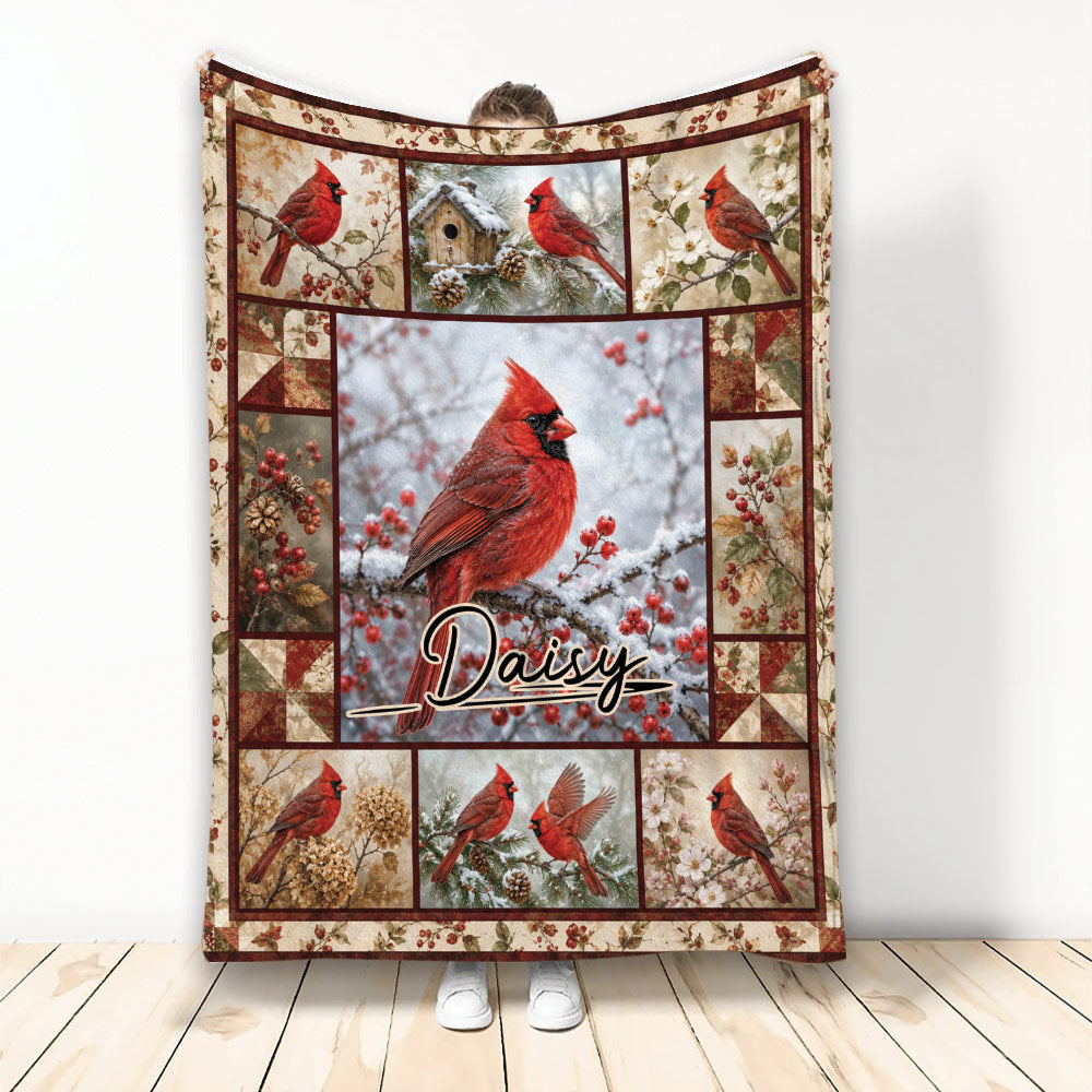 Cardinal throw blanket with red birds, snowy branches, berries, and birdhouse scenes in a framed design