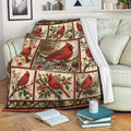 Cardinal throw blanket draped over a sofa with red bird artwork and cozy reading nook decor
